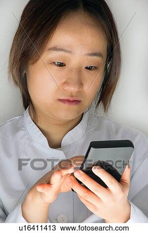 Stock Image - Scientist using calculator. Fotosearch