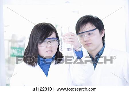 Scientists examining liquid in lab View Large Photo Image Stock Image - Scientists examining liquid in lab. Fotosearch