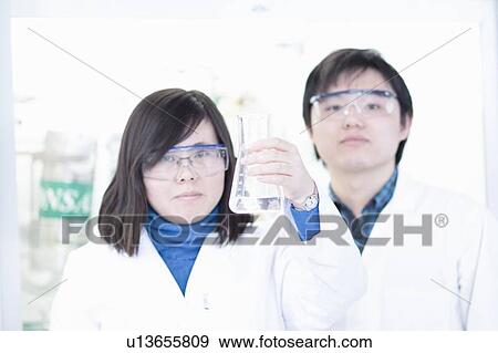 Scientists examining liquid in lab View Large Photo Image Stock Photo - Scientists examining liquid in lab. Fotosearch