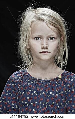 Serious girl standing indoors View Large Photo Image Stock Image - Serious girl standing indoors. Fotosearch