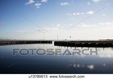 Sky reflected in still harbor View Large Photo Image Stock Image - Sky reflected in still harbor. Fotosearch
