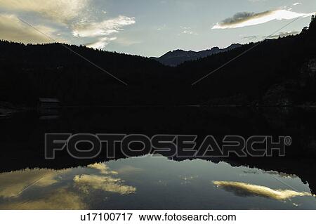 Sky reflected in still rural lake View Large Photo Image Stock Photo - Sky reflected in still rural lake. Fotosearch