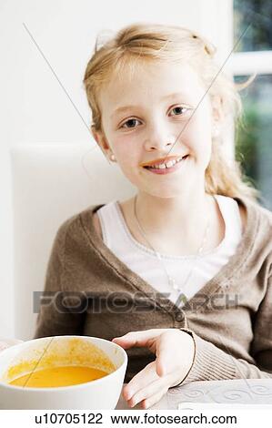 Smiling girl holding bowl of soup View Large Photo Image Stock Image - Smiling girl holding bowl of soup. Fotosearch