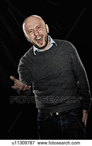 Smiling man holding hand out View Large Photo Image Stock Photo - Smiling man holding hand out. Fotosearch