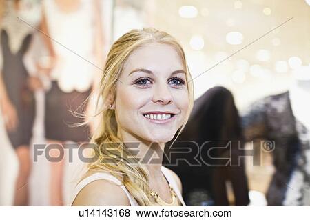 Smiling woman shopping in mall View Large Photo Image Stock Photo - Smiling woman shopping in mall. Fotosearch