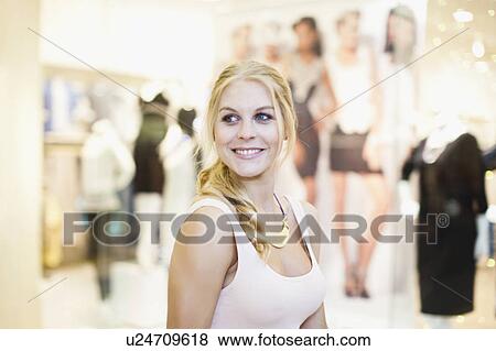 Smiling woman shopping in mall View Large Photo Image Stock Photo - Smiling woman shopping in mall. Fotosearch