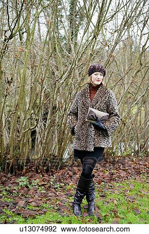 Smiling woman standing in forest View Large Photo Image Stock Image - Smiling woman standing in forest. Fotosearch