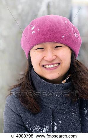 Smiling woman standing in snow View Large Photo Image Stock Photo - Smiling woman standing in snow. Fotosearch