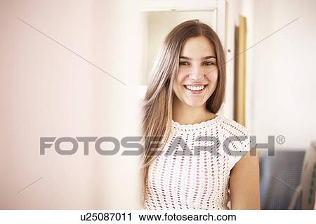 Smiling woman standing indoors View Large Photo Image Stock Image - Smiling woman standing indoors. Fotosearch