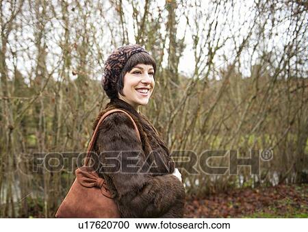Smiling woman walking in forest View Large Photo Image Stock Image - Smiling woman walking in forest. Fotosearch