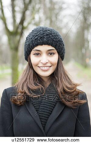 Stock Photo - Smiling woman walking outdoors. Fotosearch