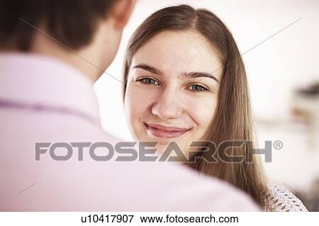 Stock Photo - Smiling woman with boyfriend. Fotosearch