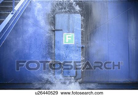 Stock Photo - Smoke pouring from behind steel door. Fotosearch