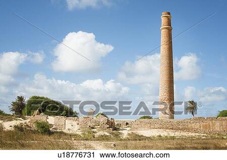 Stock Image - Smokestack over stone ruins. Fotosearch