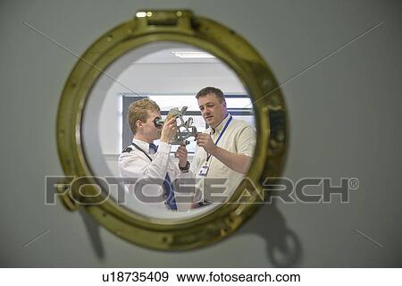 Stock Photo - Student and teacher using sextant. Fotosearch