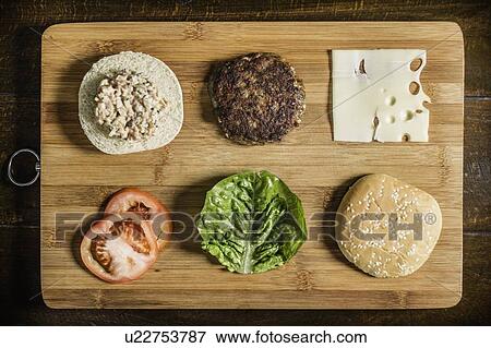 Table with hamburger and condiments View Large Photo Image Stock Photo - Table with hamburger and condiments. Fotosearch