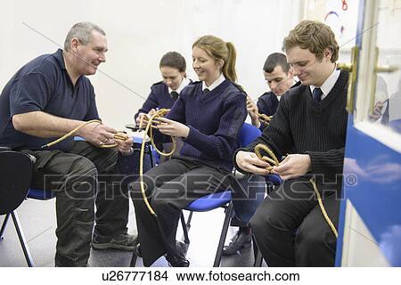 Picture - Teacher demonstrating nautical knots. Fotosearch