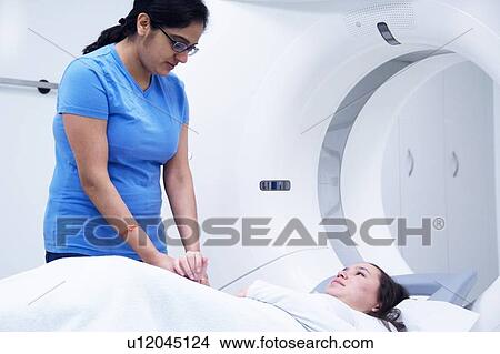 Picture - Technician with patient in CT scanner. Fotosearch