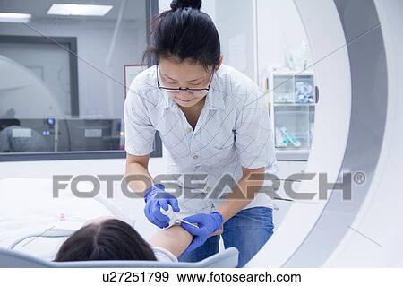 Technician with patient in CT scanner View Large Photo Image Stock Photo - Technician with patient in CT scanner. Fotosearch