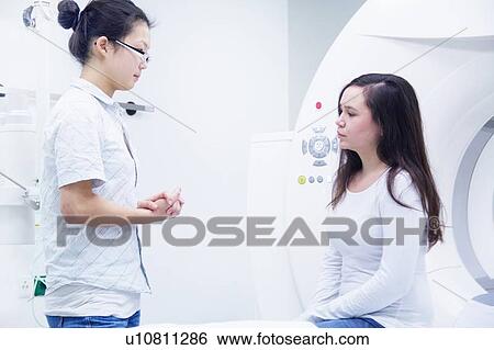 Stock Photograph - Technician with patient in CT scanner. Fotosearch