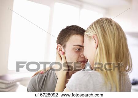 Teenage couple hugging indoors View Large Photo Image Stock Image - Teenage couple hugging indoors. Fotosearch