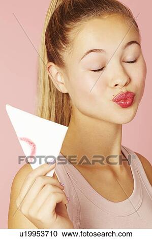 Teenage girl blotting lipstick on napkin View Large Photo Image Stock Image - Teenage girl blotting lipstick on napkin. Fotosearch
