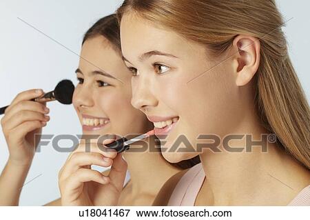 Teenage girls applying makeup View Large Photo Image Stock Photo - Teenage girls applying makeup. Fotosearch