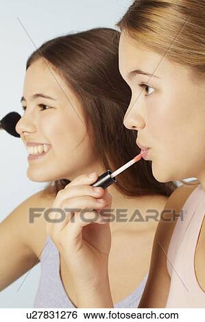 Teenage girls applying makeup View Large Photo Image Stock Photograph - Teenage girls applying makeup. Fotosearch