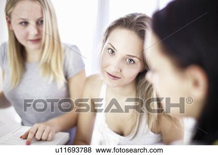 Teenage girls sitting together View Large Photo Image Stock Photo - Teenage girls sitting together. Fotosearch