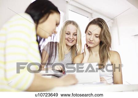 Teenage girls studying together View Large Photo Image Stock Photo - Teenage girls studying together. Fotosearch