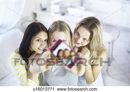 Teenage girls taking picture together View Large Photo Image Stock Image - Teenage girls taking picture together. Fotosearch