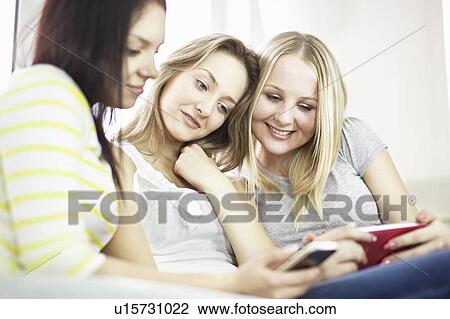Teenage girls using cell phones View Large Photo Image Stock Image - Teenage girls using cell phones. Fotosearch