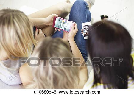 Teenage girls using cell phones View Large Photo Image Stock Photograph - Teenage girls using cell phones. Fotosearch