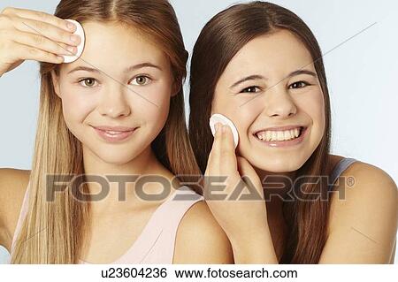 Teenage girls wiping their faces View Large Photo Image Stock Photograph - Teenage girls wiping their faces. Fotosearch
