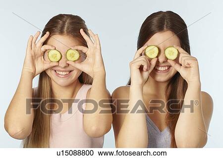 Teenage girls with cucumbers over eyes View Large Photo Image Stock Image - Teenage girls with cucumbers over eyes. Fotosearch