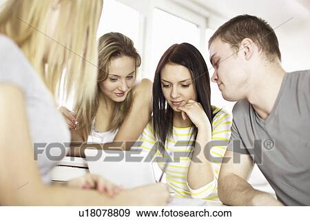 Teenagers using laptop together View Large Photo Image Stock Photo - Teenagers using laptop together. Fotosearch