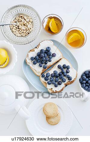 Stock Image - Toast with blueberries, nuts and tea. Fotosearch