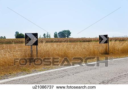 Traffic arrows on rural road View Large Photo Image Stock Photo - Traffic arrows on rural road. Fotosearch