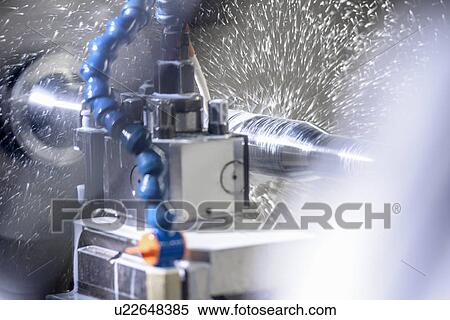Stock Photography - Water spraying on machinery in factory. Fotosearch