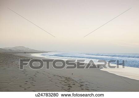 Stock Image - Waves washing up on beach. Fotosearch