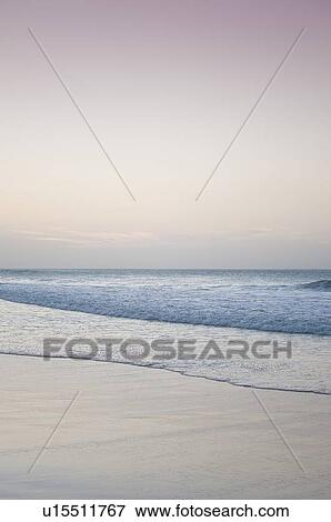 Waves washing up on beach View Large Photo Image Stock Photo - Waves washing up on beach. Fotosearch