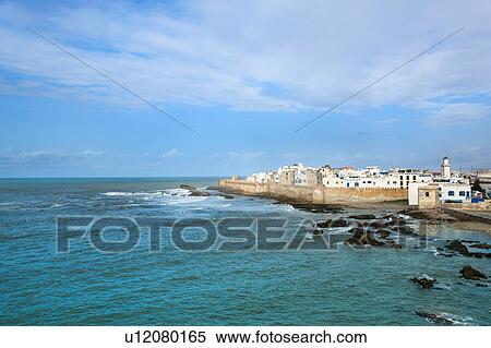 Stock Photography - Waves washing up on rocky beach. Fotosearch