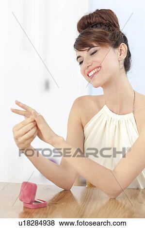 Woman admiring engagement ring View Large Photo Image Stock Photo - Woman admiring engagement ring. Fotosearch