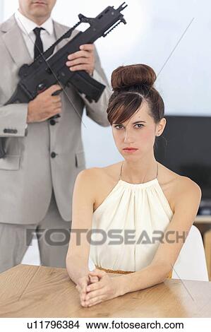 Picture - Woman and boyfriend with machine gun. Fotosearch