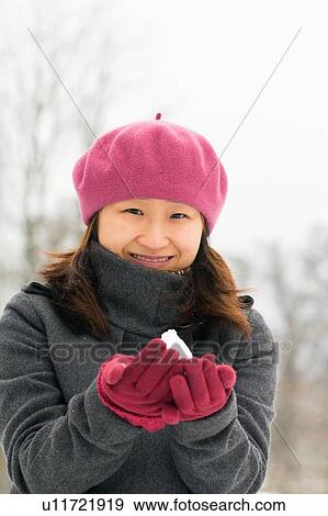 Stock Photo - Woman holding handful of snow. Fotosearch