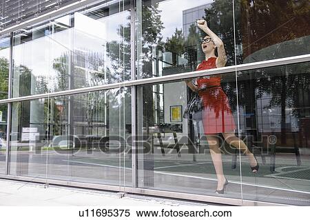 Stock Photography - Woman knocking on window. Fotosearch