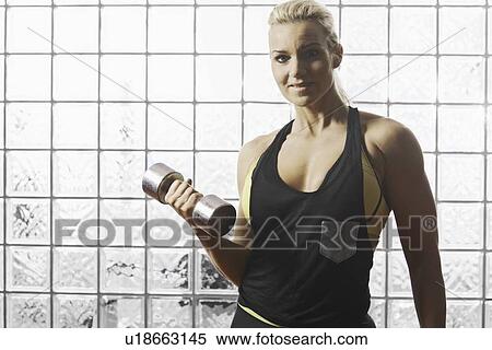 Woman lifting weights in gym View Large Photo Image Stock Photography - Woman lifting weights in gym. Fotosearch