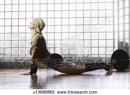 Woman practicing yoga in gym View Large Photo Image Stock Photography - Woman practicing yoga in gym. Fotosearch
