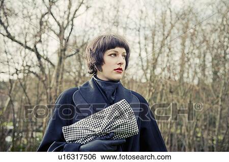Woman standing in forest View Large Photo Image Stock Photograph - Woman standing in forest. Fotosearch