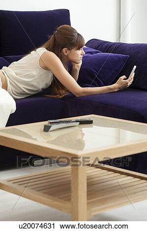Woman taking picture of herself on sofa View Large Photo Image Stock Image - Woman taking picture of herself on sofa. Fotosearch